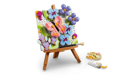 LEGO floral easel painting with brush, paint tube and palette beside it