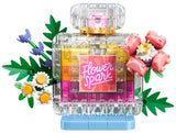 LEGO floral perfume bottle build with clear bricks, pink label, flowers and green leaves