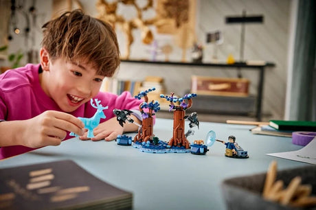 Child building a LEGO Harry Potter Forbidden Forest set at a table with tree pieces, minifigures and tablet instructions