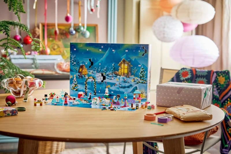 Opened LEGO Friends Advent Calendar displayed on a Christmas table with minidolls, animals and winter builds