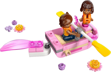 Built LEGO Friends axolotl themed boat with Paisley minidoll rowing and Axel microdoll standing on the boat