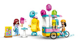 Assembled LEGO Friends ice cream and balloon cart in white, pink and teal, attached to a light blue bicycle with Liann, Paisley and accessories