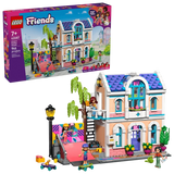 LEGO Friends Liann's Family House 42687 retail box displayed beside the completed two storey house, showing the purple roof, balcony, skate ramp, minidolls and garden accessories.