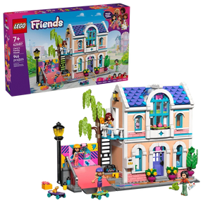 LEGO Friends Liann's Family House 42687 retail box displayed beside the completed two storey house, showing the purple roof, balcony, skate ramp, minidolls and garden accessories.
