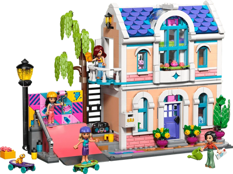 LEGO Friends Liann's Family House 42687 showing the two storey house with purple tiled roof, balcony, colourful skate ramp, tree, minidolls and outdoor accessories.