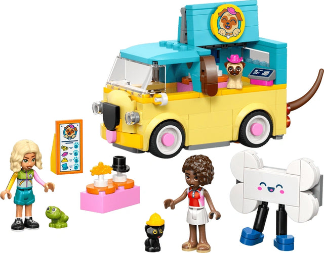 LEGO Friends Pet Accessories Van 42678 yellow pug themed van with teal roof shown beside Nova and Aliya minidolls, dog, kitten and frog figures, and pet accessory stand