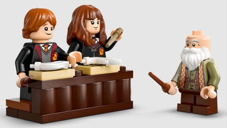 LEGO Harry Potter Ron, Hermione, and Professor Flitwick minifigures with classroom desk