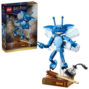 LEGO Harry Potter Cornish Pixie set showing retail box beside the assembled blue pixie figure posed on a display stand with book and ink bottle accessories on a white background
