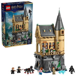 LEGO Harry Potter Hogwarts Castle Hospital Wing 76463 box shown beside the assembled tan tower build on a grey rocky base with minifigures, black spider and blue wolf figure
