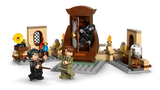 Close up LEGO scene with brown wardrobe opening, black hooded Dementor figure emerging, Harry Potter and another minifigure holding wands, and small display builds with bottles, lamp and glass dome