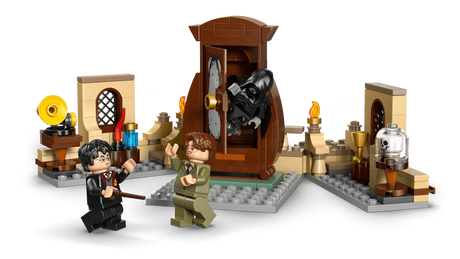 Close up LEGO scene with brown wardrobe opening, black hooded Dementor figure emerging, Harry Potter and another minifigure holding wands, and small display builds with bottles, lamp and glass dome