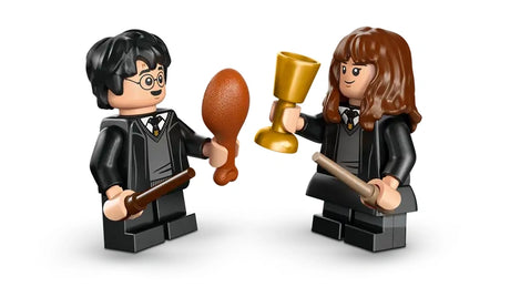 LEGO Harry Potter and Hermione Granger minifigures holding wands with goblet and food accessories on a white background