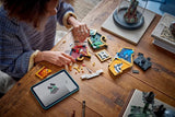Child building a LEGO Hogwarts house crest set at a table with pieces, display model and tablet instructions