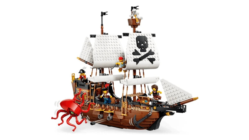 Side view of LEGO pirate ship with white sails, red sea monster, cannon and pirate minifigures