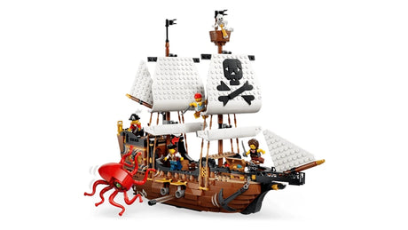 Side view of LEGO pirate ship with white sails, red sea monster, cannon and pirate minifigures
