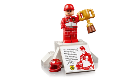 LEGO Icons Michael Schumacher minifigure in red racing suit holding trophy on podium display stand with printed quote