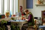 Adult builder positioning the LEGO Ideas E.T. the Extra-Terrestrial 21370 model on a desk