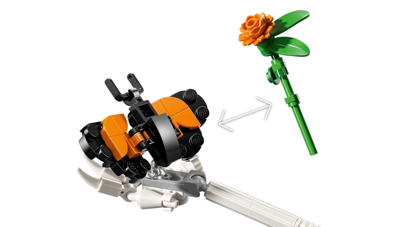 Close-up of the LEGO Ideas La Catrina 21372 orange butterfly and flower accessories with arrows between them