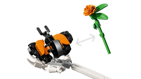 Close-up of the LEGO Ideas La Catrina 21372 orange butterfly and flower accessories with arrows between them