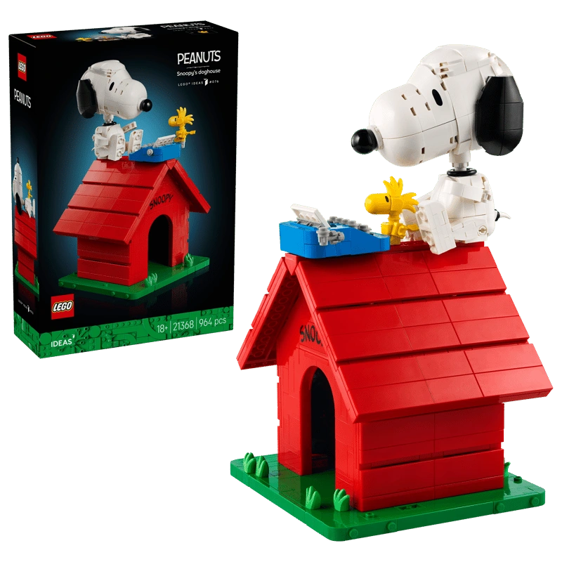 LEGO Ideas Peanuts Snoopy's Doghouse 21368 retail box beside the completed red doghouse, with Snoopy, Woodstock and a blue typewriter on the roof.