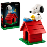 LEGO Ideas Peanuts Snoopy's Doghouse 21368 retail box beside the completed red doghouse, with Snoopy, Woodstock and a blue typewriter on the roof.