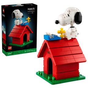 LEGO Ideas Peanuts Snoopy's Doghouse 21368 retail box beside the completed red doghouse, with Snoopy, Woodstock and a blue typewriter on the roof.