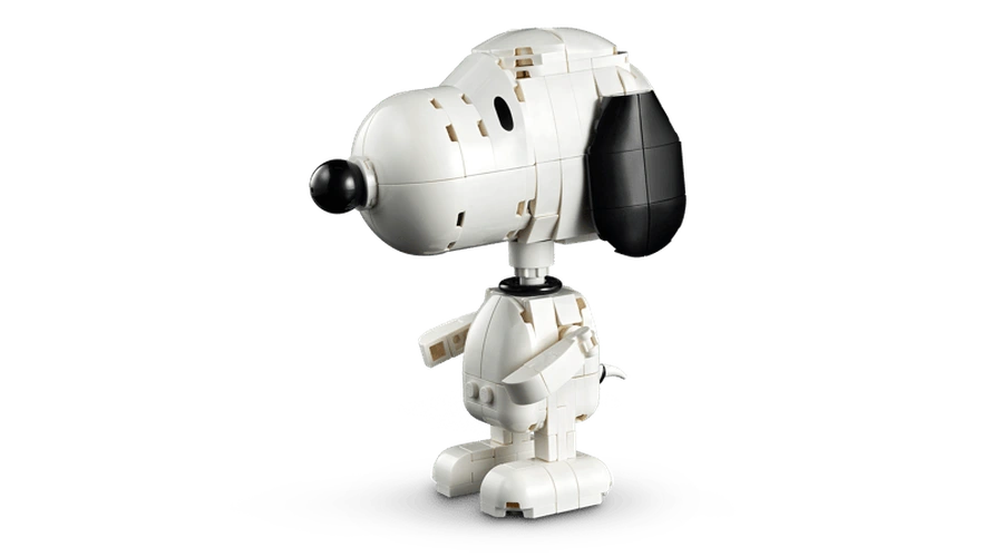 Standing LEGO Snoopy figure viewed from the side, showing his white body, black ear and nose, arms and feet.