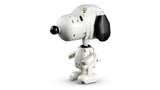 Standing LEGO Snoopy figure viewed from the side, showing his white body, black ear and nose, arms and feet.