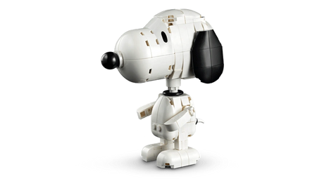 Standing LEGO Snoopy figure viewed from the side, showing his white body, black ear and nose, arms and feet.