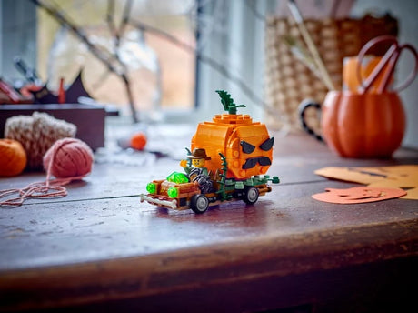 LEGO Jack-O'-Lantern Pickup Truck 40822 displayed on a table with Halloween craft decorations