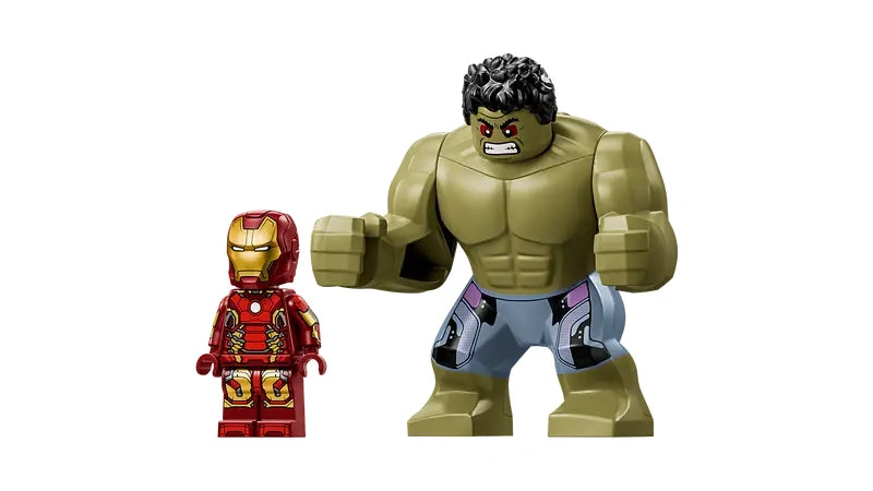 LEGO Iron Man minifigure standing next to large Hulk figure with green skin and grey shorts on a white background