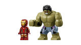 LEGO Iron Man minifigure standing next to large Hulk figure with green skin and grey shorts on a white background