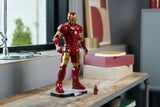 LEGO Iron Man Mark 3 model displayed on a wooden table beside the Iron Man minifigure and stacked books 