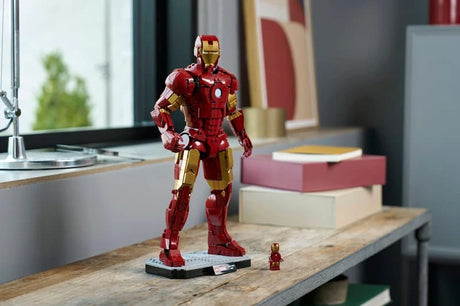 LEGO Iron Man Mark 3 model displayed on a wooden table beside the Iron Man minifigure and stacked books 
