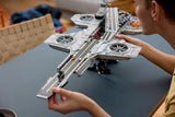 Person fitting the long front runway section onto the LEGO Marvel S.H.I.E.L.D. Helicarrier model