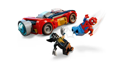 Spider-Man minifigure shown mid air striking the Venomized Wolverine minifigure, with Spider-Man angled forward in an attack pose and Venomized Wolverine recoiling beneath him, while the red and blue Spider-Man car is positioned behind them on a white background