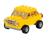 LEGO Medium Creative Brick Box 10696 yellow car model with black tyres, clear windows, round headlights and grey front bumper.
