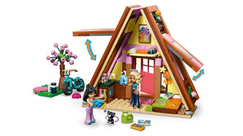 LEGO Friends A-frame cabin opened to show the interior with mini-dolls, kitten, bike and garden area