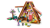LEGO Friends A-frame cabin opened to show the interior with mini-dolls, kitten, bike and garden area
