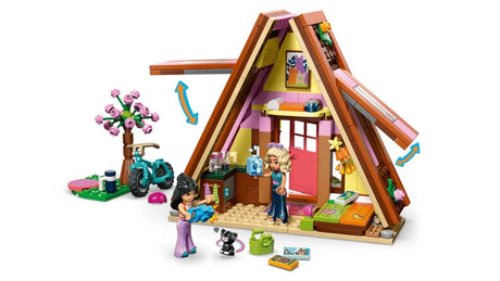 LEGO Friends A-frame cabin opened to show the interior with mini-dolls, kitten, bike and garden area