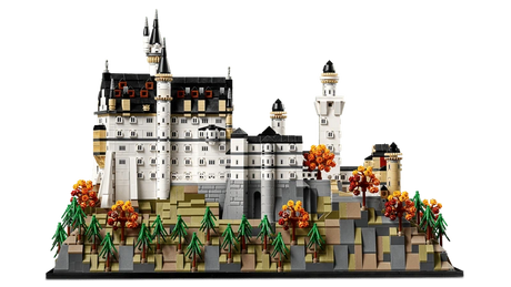 LEGO Neuschwanstein Castle 21063 side view showing the castle walls, towers, rocky hillside base, pine trees and orange autumn trees