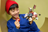 Child holding a LEGO NINJAGO white dragon beast model and red minifigure
