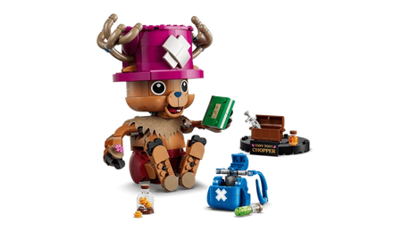 LEGO One Piece Tony Tony Chopper 75643 figure seated beside a green book, bottles, blue backpack and display stand