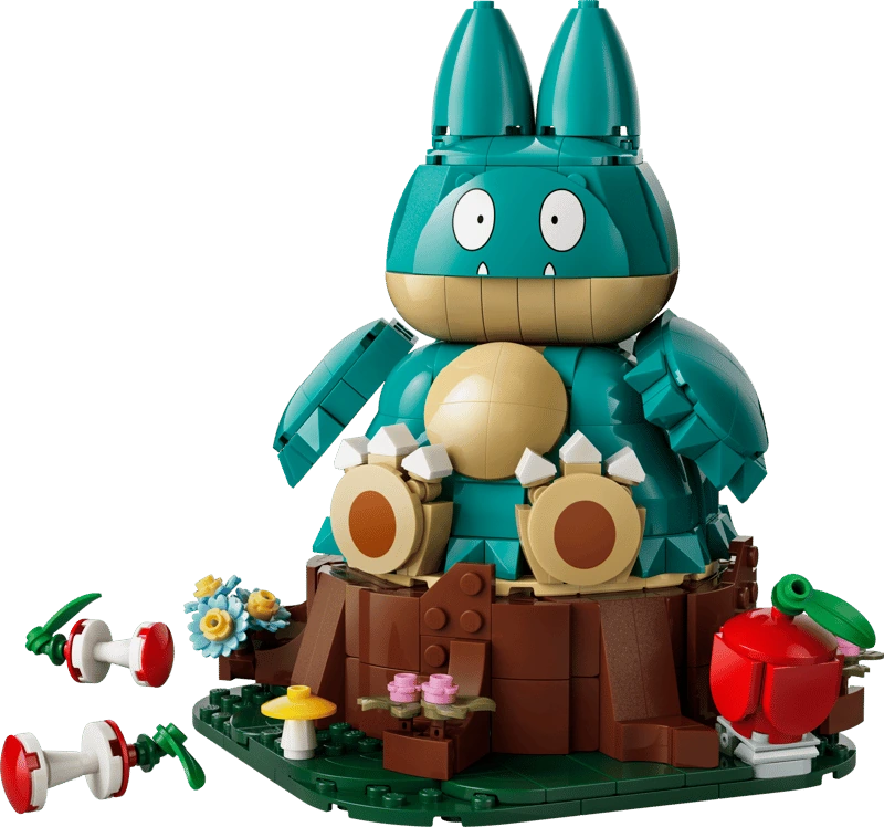 Completed LEGO Pokémon Munchlax 72150 model seated on a tree stump with an apple and two apple cores