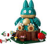 Completed LEGO Pokémon Munchlax 72150 model seated on a tree stump with an apple and two apple cores