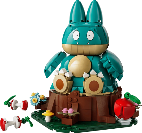 Completed LEGO Pokémon Munchlax 72150 model seated on a tree stump with an apple and two apple cores