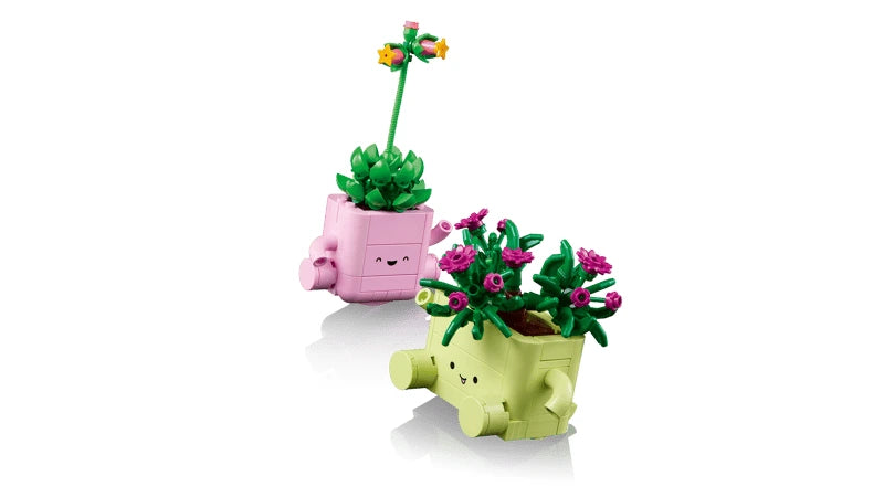 Two LEGO plant models standing upright in smiling pastel pots