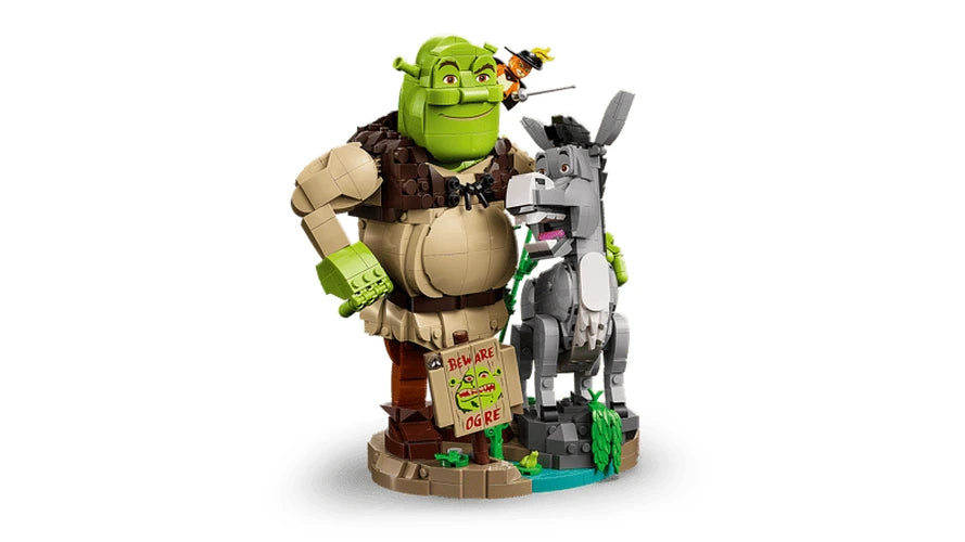 Angled side view of LEGO Shrek, Donkey & Puss in Boots 72423 showing Shrek beside Donkey, Puss in Boots perched above and the swamp base.