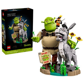LEGO Shrek, Donkey & Puss in Boots 72423 retail box alongside the assembled character figures, sunflowers and Beware Ogre sign.