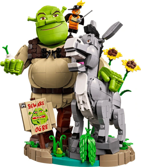 Close-up of LEGO Shrek, Donkey & Puss in Boots 72423 featuring Shrek holding an onion, Donkey, Puss in Boots, sunflowers and the Beware Ogre sign.